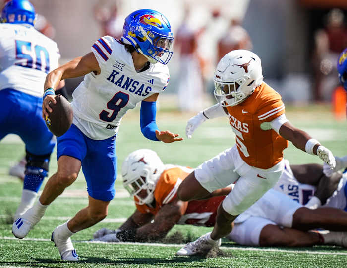 Texas Longhorns defensive back Malik Muhammad (5) tries to tackle Kansas Jayhawks quarterback Jason Bean (9) Saturday at Darrell K Royal-Texas Memorial Stadium. The Longhorns won 40-14.